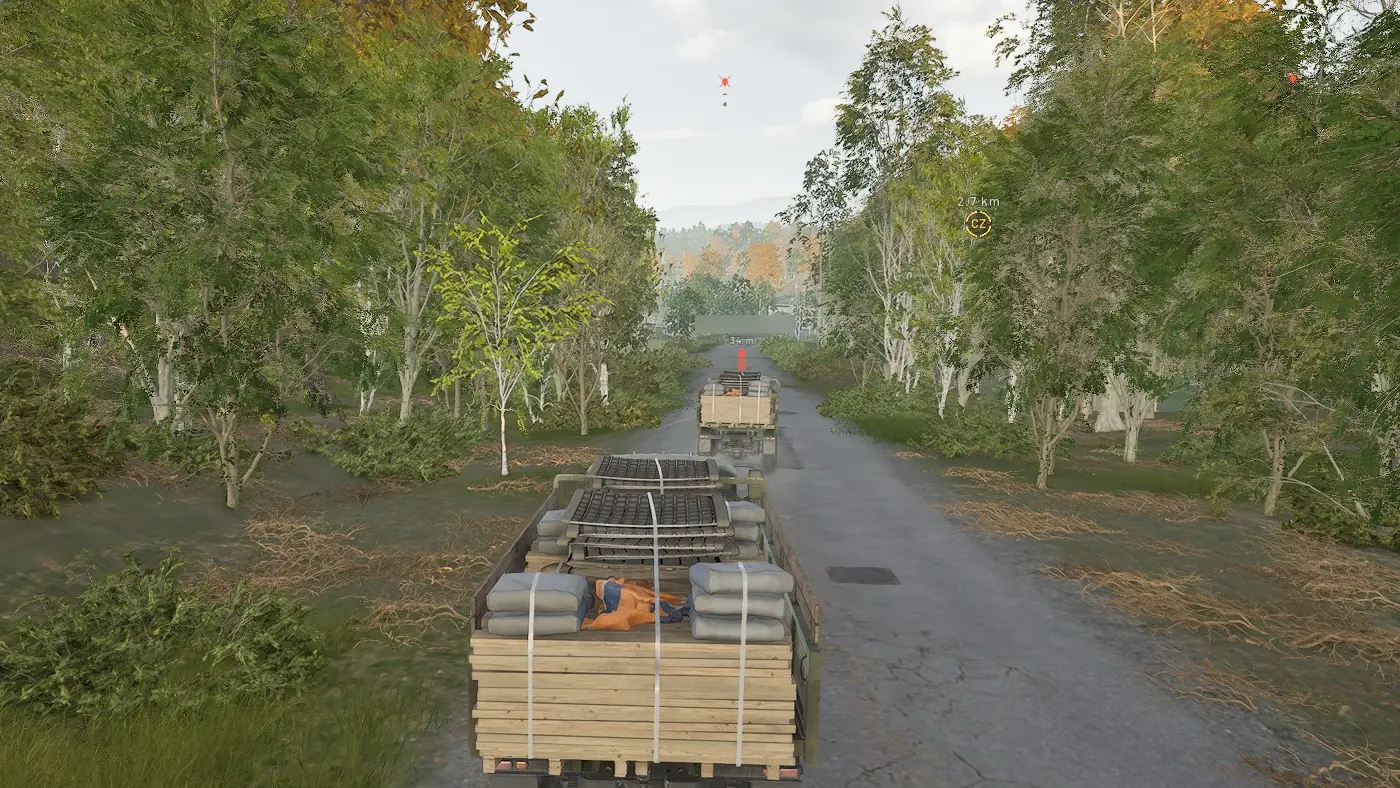 Driving a loaded Ural through birch woods behind another supply truck